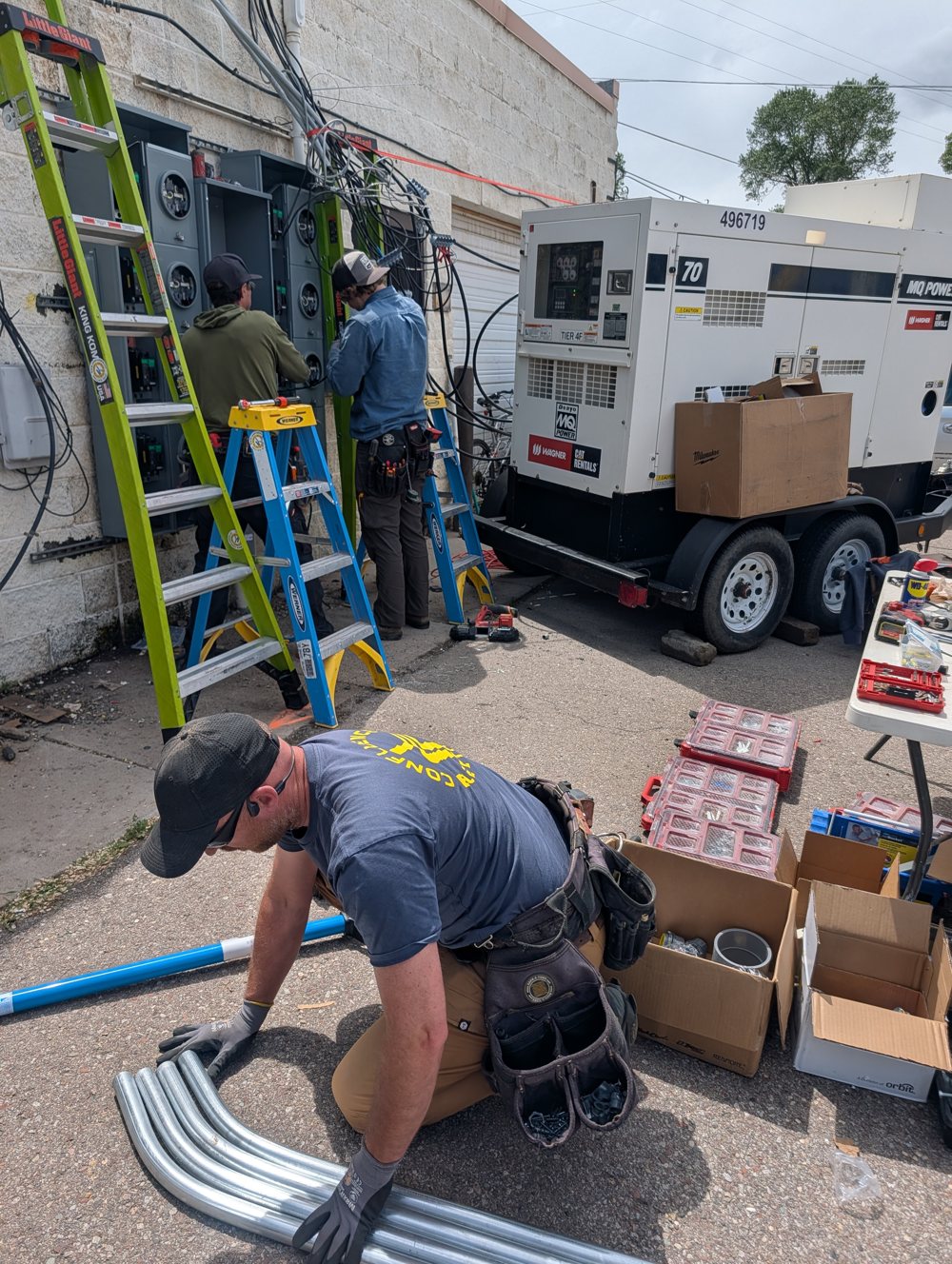 Crew bending conduit with a temporary power generator on site