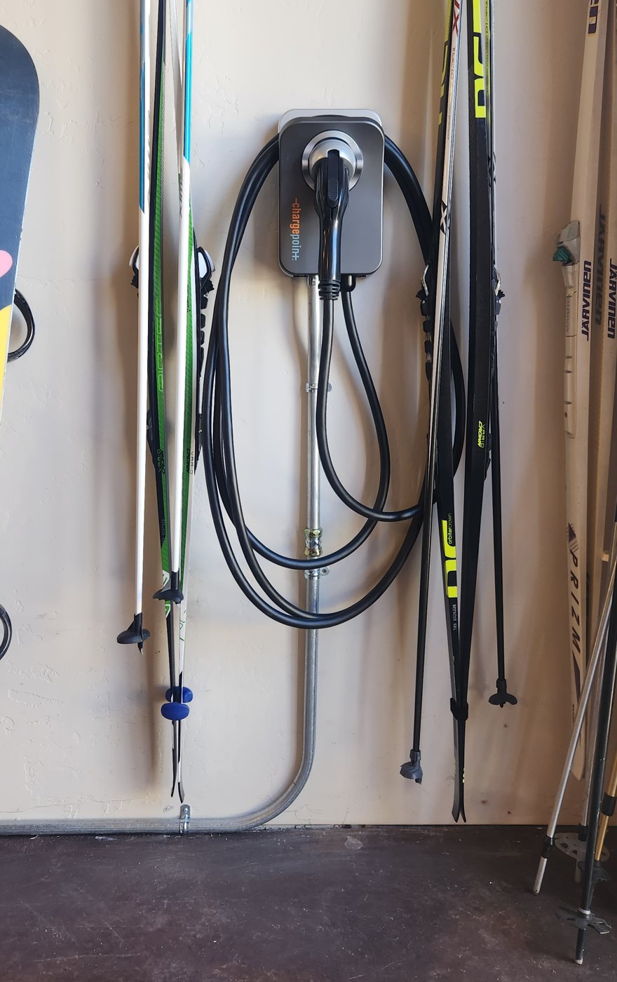 ChargePoint Home Flex installed on a garage wall with conduit run to the panel