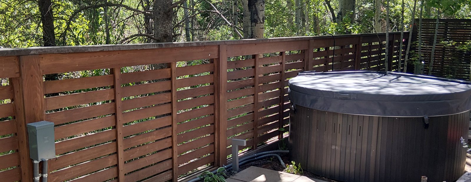 GFCI disconnect and conduit run to a hot tub on a patio in the aspens